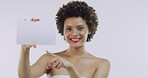 Portrait, beauty and woman with board for skincare, space or cosmetics on white background. Pointing, smile or female person in advertising studio with dermatology banner, promo card or poster mockup