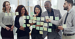 Sticky notes, meeting and business people in office for planning with creative project together. Discussion, research and team of editors with glass wall for brainstorming for publishing in workplace