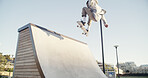 Man, skateboard and ramp in city, training and fitness with freestyle practice, sports and exercise. Person, skater and talent with stunt, outdoor and workout with competition and performing action
