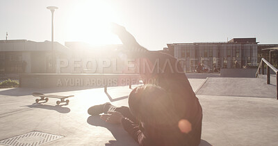 Buy stock photo Skater, person and fall outdoor with injury, exercise mistake and trick fail with medical emergency. Skatepark, sports accident and skateboarder with pain, wipeout and lose balance in city with flare