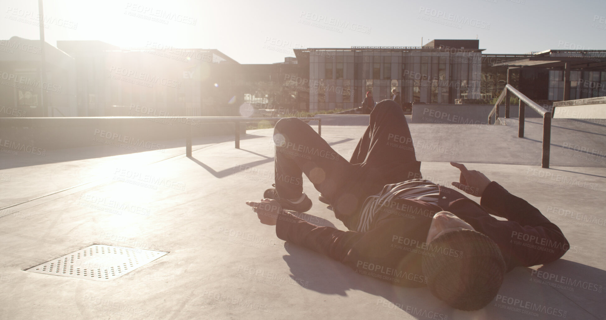 Buy stock photo Skater, man and accident outdoor with injury, exercise mistake and trick fail. Skatepark, sports and skateboarder fall with pain, crash and lose balance with medical emergency in city with flare