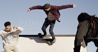 Buy stock photo Men, skateboard and friends on ramp at park with trick, outdoor and culture with streetwear in city. People, skater group and training with balance, hobby and low angle with sky for extreme sports