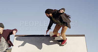Buy stock photo Men, skateboard and hobby on ramp at park with trick, outdoor and culture with streetwear in city. People, skater friends and training with balance, action and low angle with sky for extreme sports