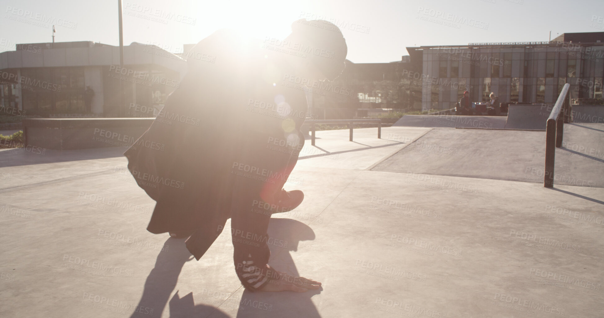 Buy stock photo Skating, city and man in park with skateboard for learning tricks, skills and practice outdoor. Flare, sunlight and back of person for sports, training and skater exercise in town for challenge