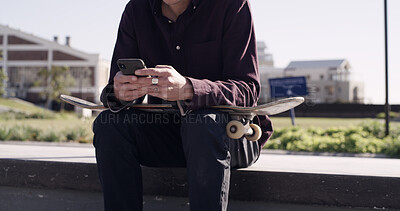Buy stock photo Skater, hands and typing with phone in city for texting, check skating schedule and social media. Skateboard, man and smartphone at skatepark for internet browsing, online videos and practice break