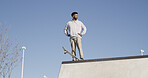 Man, skateboard and thinking in city, ramp and below with extreme sports, competition and fitness. Outdoor, skater and person with training, recreation and practice with stunt performance and balance