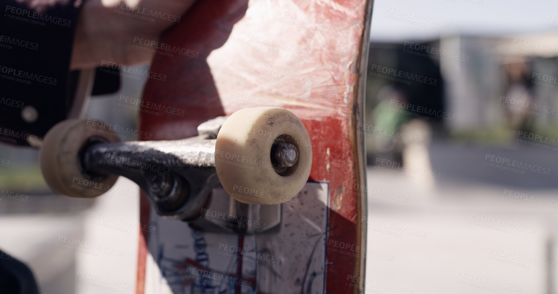 Buy stock photo Skateboard, sports and hands of person in skatepark for hobby, balance and fitness in city. Wheels, space and male skater with longboard for exercise, equipment and training outdoors for wellness