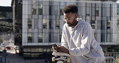 Buy stock photo Online, skateboarder and man with smartphone, texting or communication with contact, city or website. Outdoor, skater and person with tech for chat, break and networking on social media and mobile