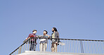 Below, people and together with skateboard, phone and together on blue sky space. Conversation, friends and gen z skater group with tech, smile and social media for fitness hobby and break for sport