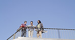 Men, skateboard and phone with blue sky below for social media, network or tips and tricks. Low angle, male people or group of friends with mobile smartphone for spot in an urban skate park on space