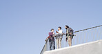 Below, people and conversation with skateboard, phone and together on blue sky space. Together, friends and gen z skater group with tech, smile and social media for fitness hobby and break for sport