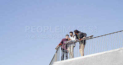 Buy stock photo Below, people and laughing with skateboard, phone and meme together on blue sky space. Bonding, friends and gen z skater group with tech, smile and social media for fitness hobby and break for sport