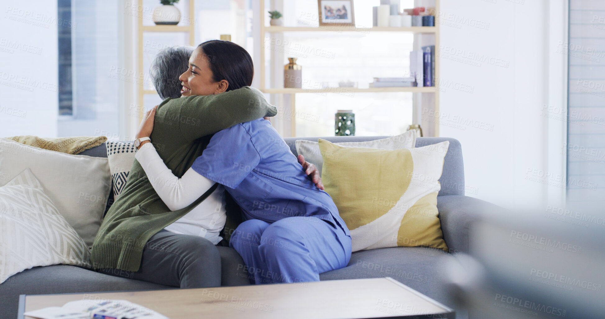 Buy stock photo Senior woman, nurse and hug in home for medical support, recovery progress or celebration. Happy, elderly patient and caregiver with embrace on sofa for health treatment success, good news or checkup