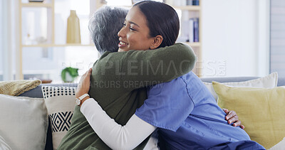 Buy stock photo Senior woman, caregiver and hug on sofa for healthcare support, medical service and bonding. Happy, elderly patient and nurse with embrace in home for health treatment success, good news and kindness