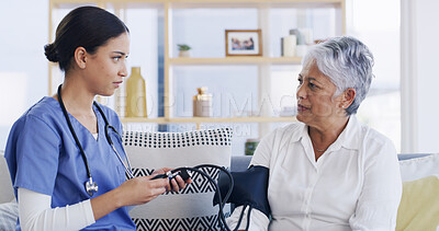 Buy stock photo Nurse, old woman and blood pressure test on sofa for assessment, hypertension or advice at house. People, patient and medical consulting with monitor, check and exam for healthcare at nursing home