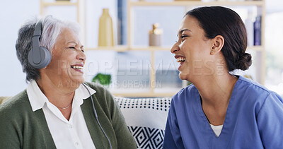 Buy stock photo Headphones, healthcare and old woman laughing with nurse in assisted living apartment for bonding. Funny, medical or music with caregiver and senior patient on sofa in home for audio streaming
