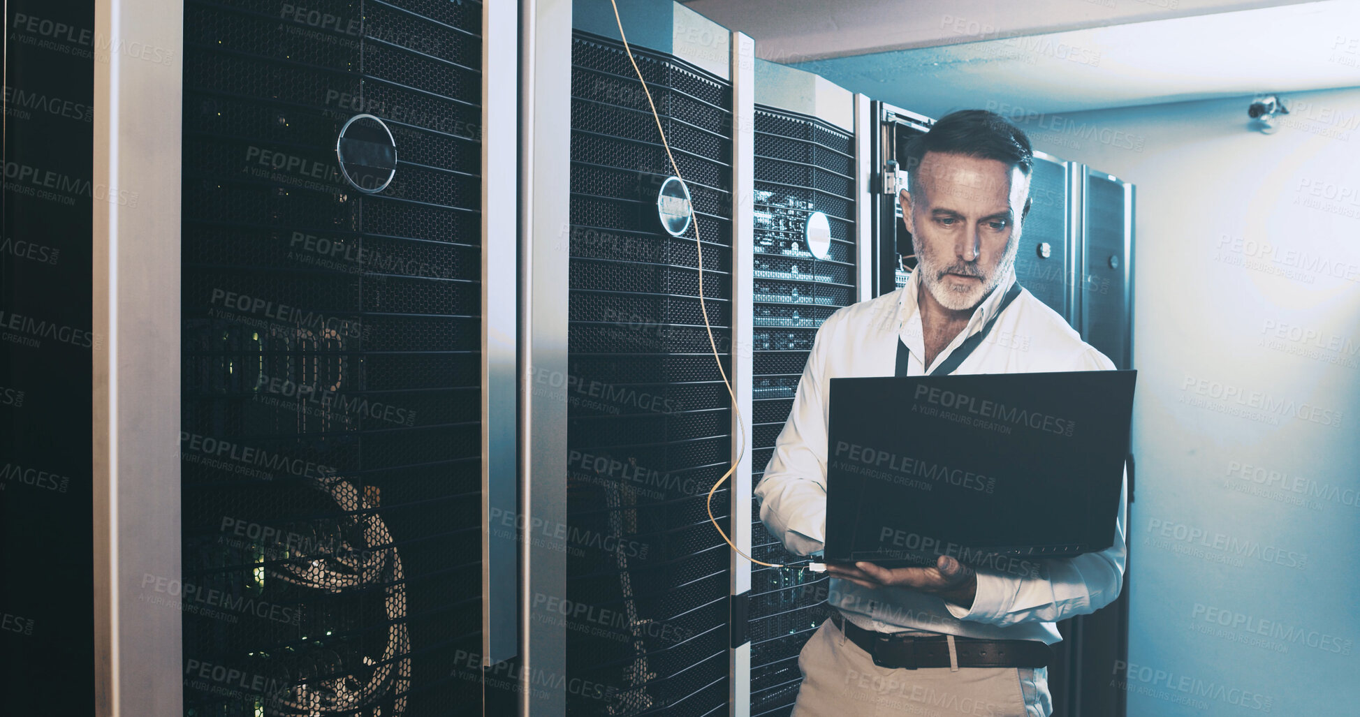 Buy stock photo Server room, programmer and man with laptop, maintenance and hardware problem solving. IT specialist, mature person and employee in workplace, pc and tech upgrade with inspection and cyber security