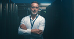 Arms crossed, mainframe and portrait of man in server room for network administration. Cloud computing, cybersecurity and system with mature tech support employee in data center for maintenance