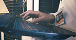 Data center, technician and hands with laptop, coding and network engineering with keyboard and web. Server room, electrician and person with tech for software upgrade, troubleshooting and online