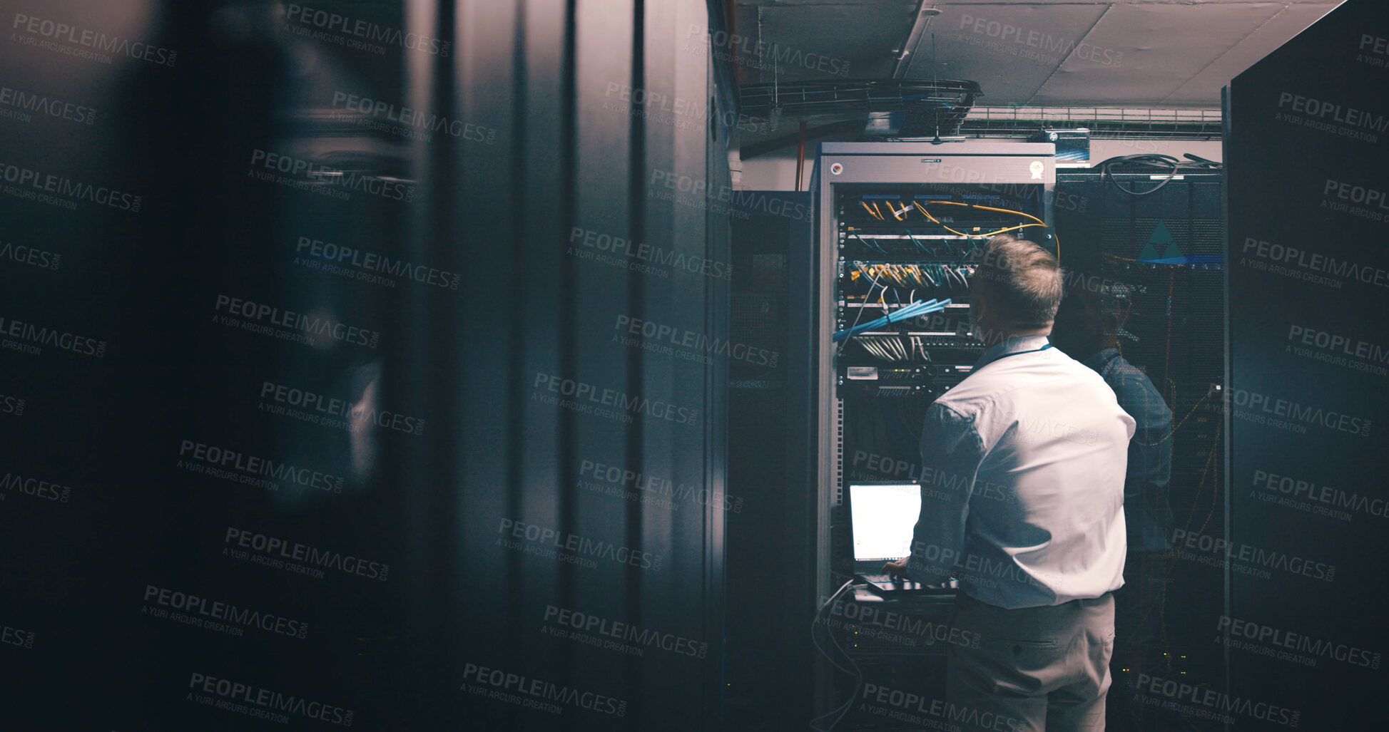 Buy stock photo Technician, back and laptop with man in server room for cybersecurity, network and system database. Software update, signal transmission and cloud computing with person in data center for maintenance