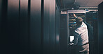Back, technician and laptop with man in server room for hosting database, inspection and cybersecurity. Hardware storage, cloud computing and system backup with mature person in data center for code