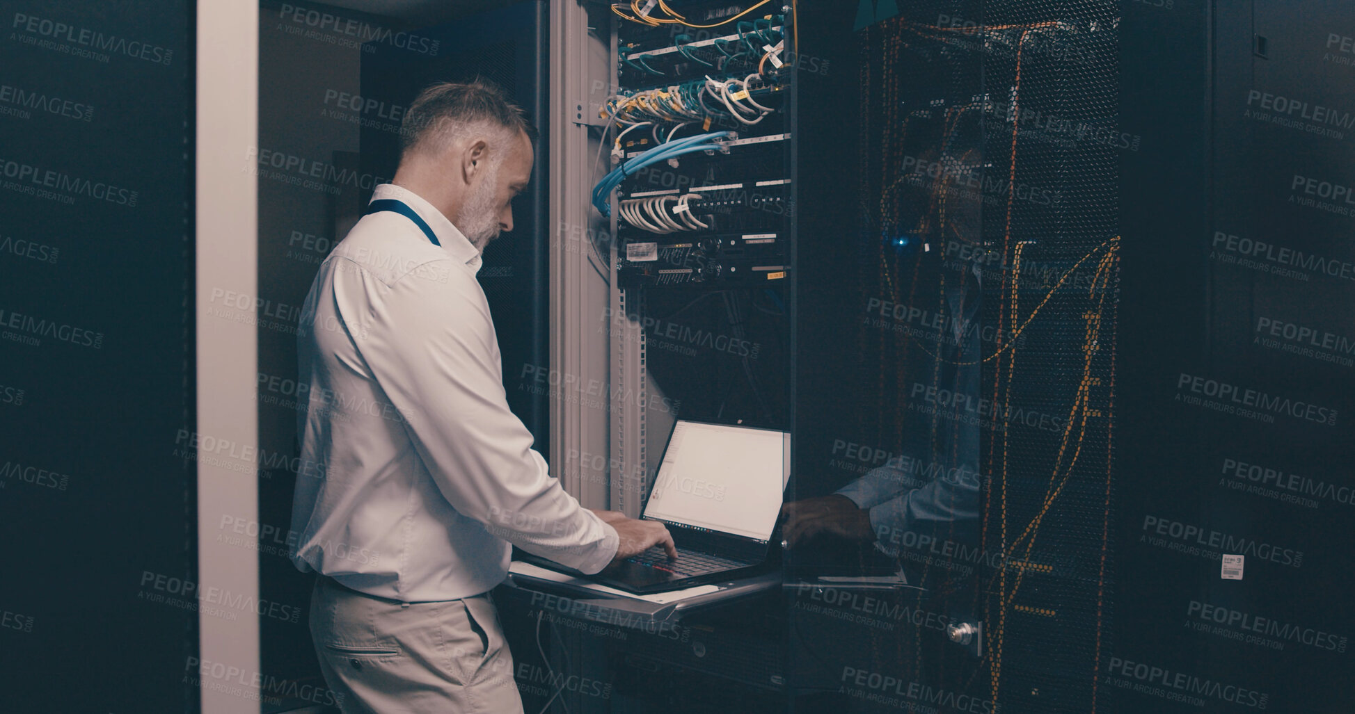 Buy stock photo Update, technician and laptop with man in server room for hosting database, inspection and cybersecurity. Hardware storage, cloud computing and system backup with mature person in data center