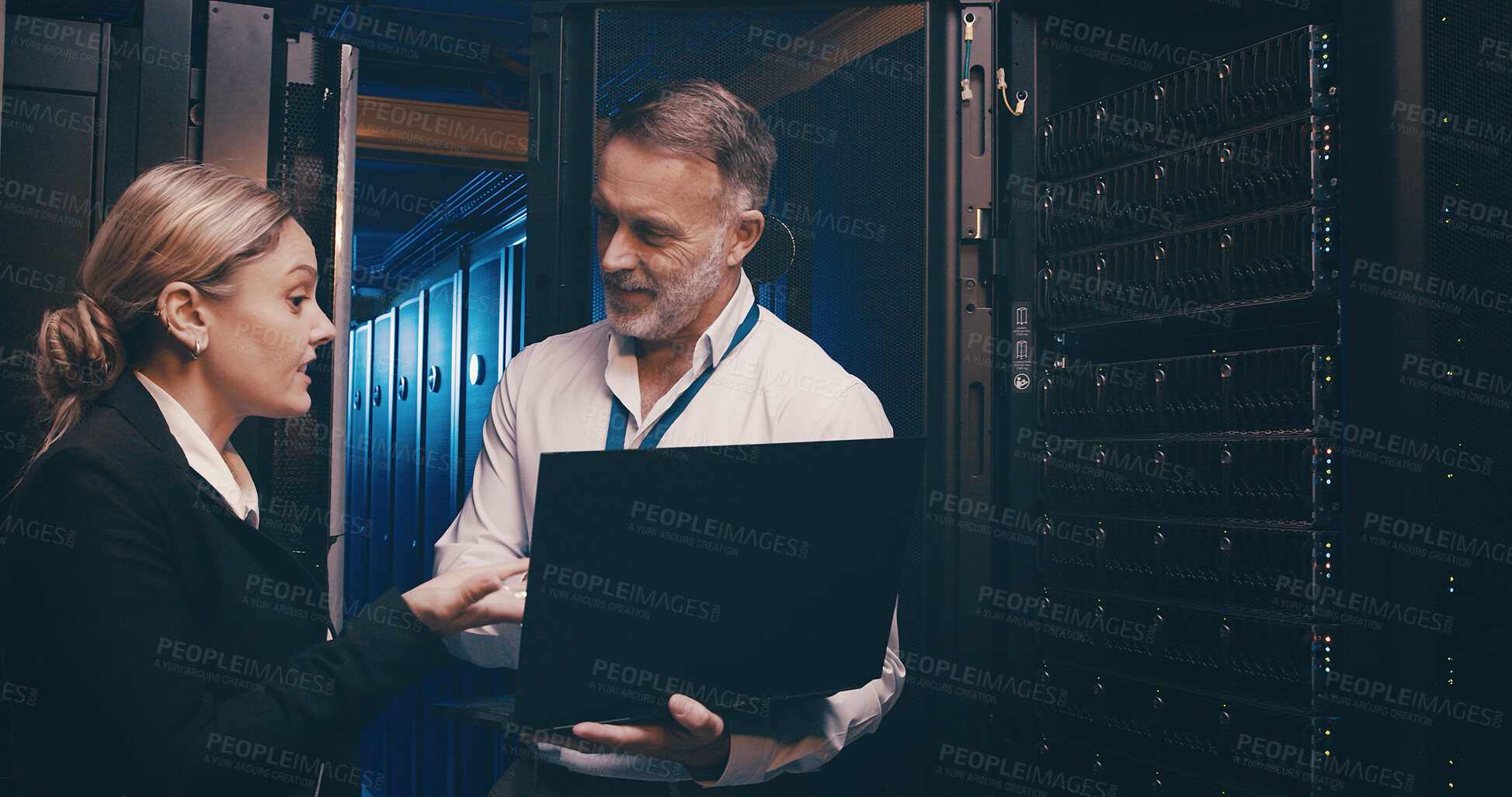 Buy stock photo Server room, online and people on laptop for network maintenance, IT support and database. Talking, technician team and man with woman on computer for diagnostics, system update and cybersecurity