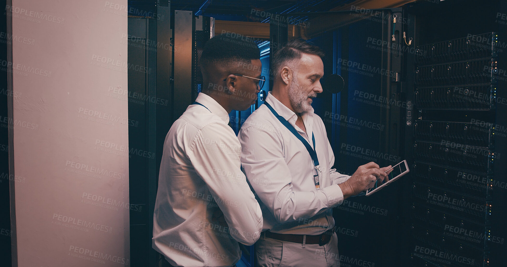 Buy stock photo Men, tablet and team in server room with maintenance, review and talk with mentor for system upgrade. People, tech and assessment with app, software update or programming for cybersecurity solution
