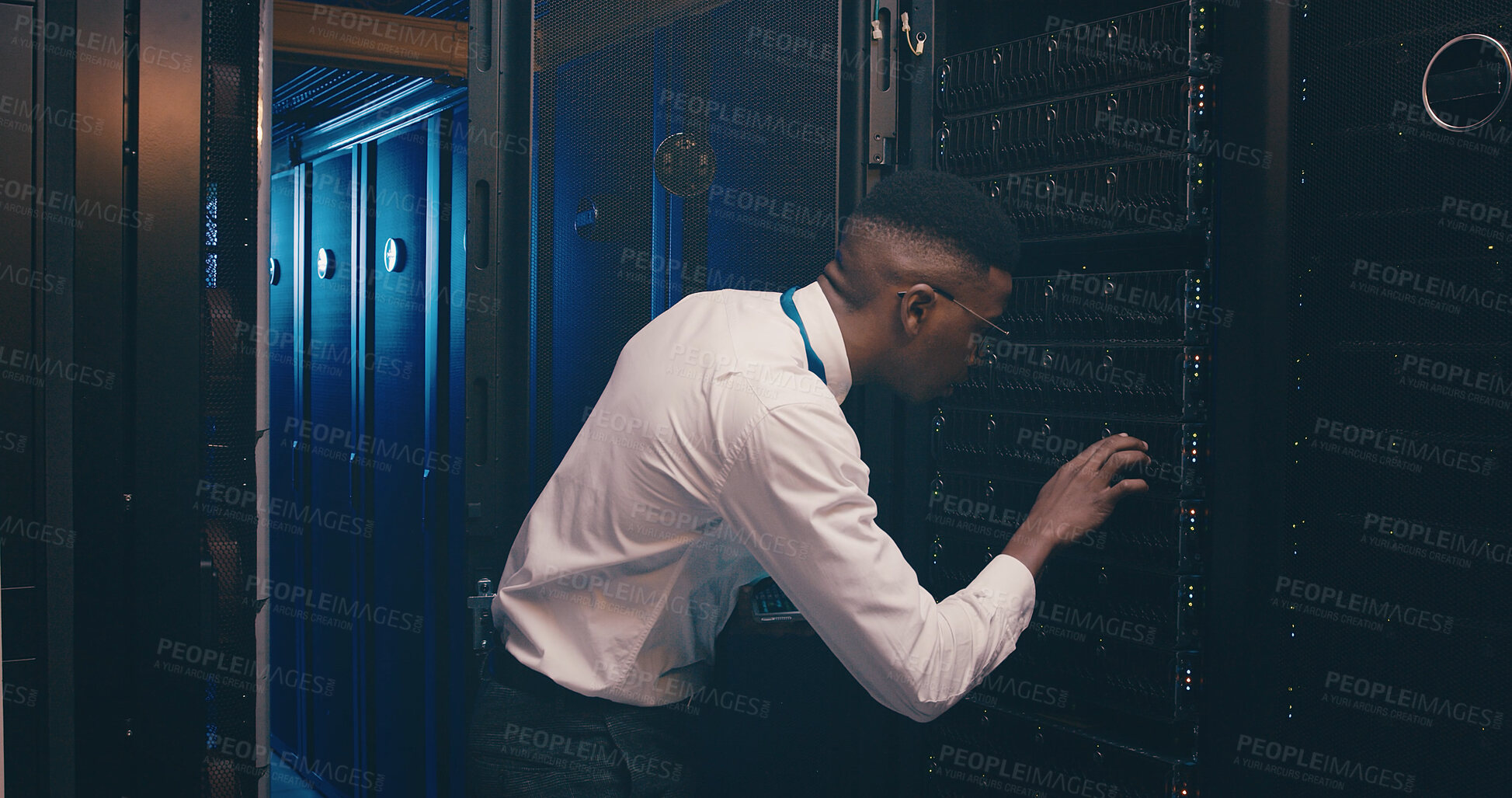 Buy stock photo Administration, checking and cybersecurity with black man in server room for network maintenance. Firewall, mainframe and service with tech support employee in data center for backup or storage