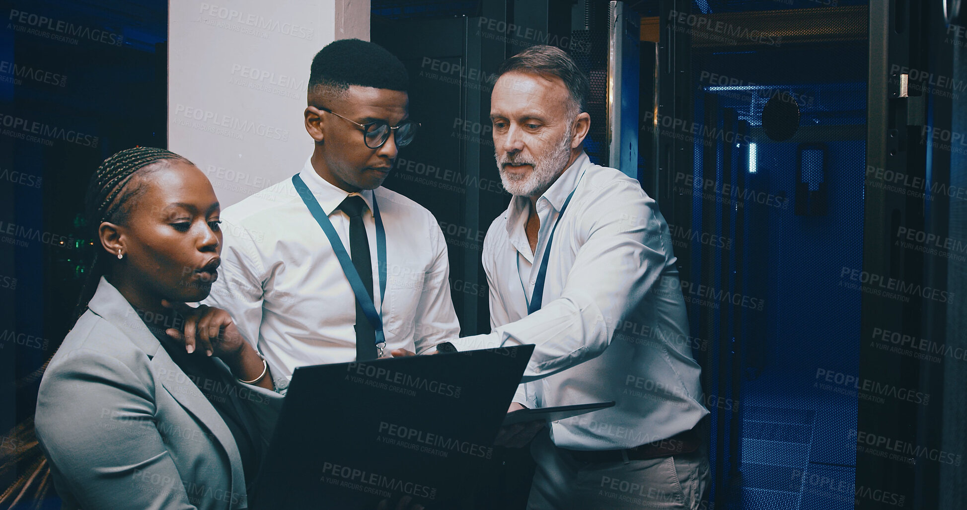 Buy stock photo Man, laptop and group with discussion in server room with cybersecurity, system or collaboration. Programmer, tech and team with insight for problem solving, assessment or IT solution at data center