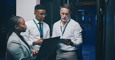 Buy stock photo Talking, cybersecurity and business people with tech in server room for network, diagnostics and IT support. Team, meeting and workers on laptop and hardware for system update, database or backup