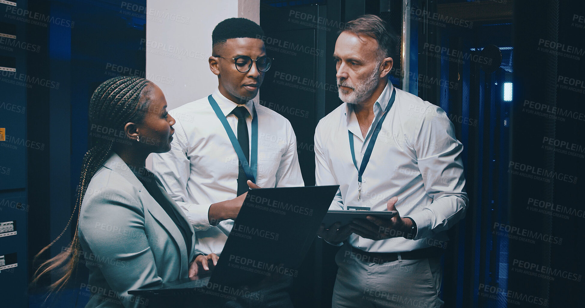 Buy stock photo Man, laptop and team with solution in server room with cybersecurity, system or collaboration. Programmer, tech and group with insight for problem solving, assessment or IT maintenance at data center
