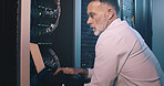 Engineer, man or typing on laptop in server room for diagnostics, system test or maintenance. Technician, mature person or technology in data center for network configuration, software update or GDPR