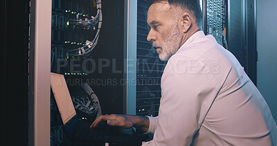 Buy stock photo Engineer, man or typing on laptop in server room for diagnostics, system test or maintenance. Technician, mature person or technology in data center for network configuration, software update or GDPR