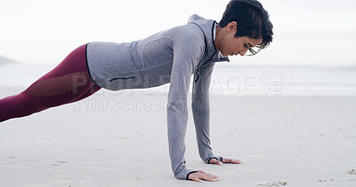 Buy stock photo Athlete, woman and pushup for exercise by ocean for fitness, strength training and strong muscles. Female person, weight and workout routine, body balance and sports performance for wellness at beach