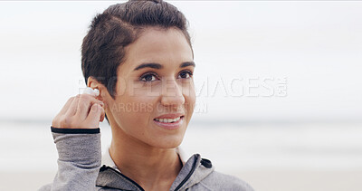 Buy stock photo Fitness, woman and earphones on beach for workout, music and training podcast for runner. Athlete, marathon and audio by ocean for exercise, physical health and wellness with California seaside space