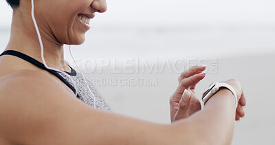 Buy stock photo Hands, music and woman with smart watch for fitness, heart rate or exercise progress. Earphones, happy runner and check wristwatch for wellness stats, timer and pace tracking for cardio at beach