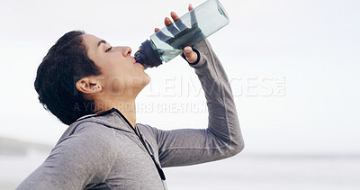 Buy stock photo Fitness, drinking water and woman by ocean for exercise, training and workout in nature. Sports, runner and person with liquid, minerals and nutrition for wellness, health and hydration outdoor