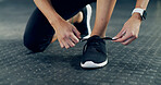 Fitness, tie shoes and hands of woman in gym for workout, start exercise and health. Bodybuilder, athlete and wellness with closeup of female person in sports club for training and cardio challenge