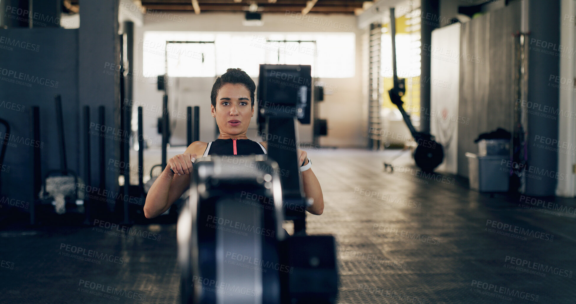 Buy stock photo Athlete, woman and fitness with rowing machine at gym of exercise, strength training and workout. Person, equipment and sports practice for bodybuilding, core activity and resilience of strong muscle