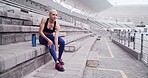 Rest, fitness and woman with injury in stadium for workout, exercise and muscle fatigue for running. Athlete, sports track and person massage legs for accident, strain and pain for training outdoor