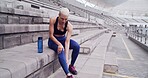 Stadium, fitness and woman with leg injury for workout, exercise and muscle fatigue for running. Athlete, sports track and person rest and massage for accident, tension and pain for training outdoor