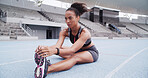 Stretching legs, sports and woman in stadium to start running, exercise and marathon training. Athlete, fitness and person with muscle warm up for workout, race competition and challenge outdoor