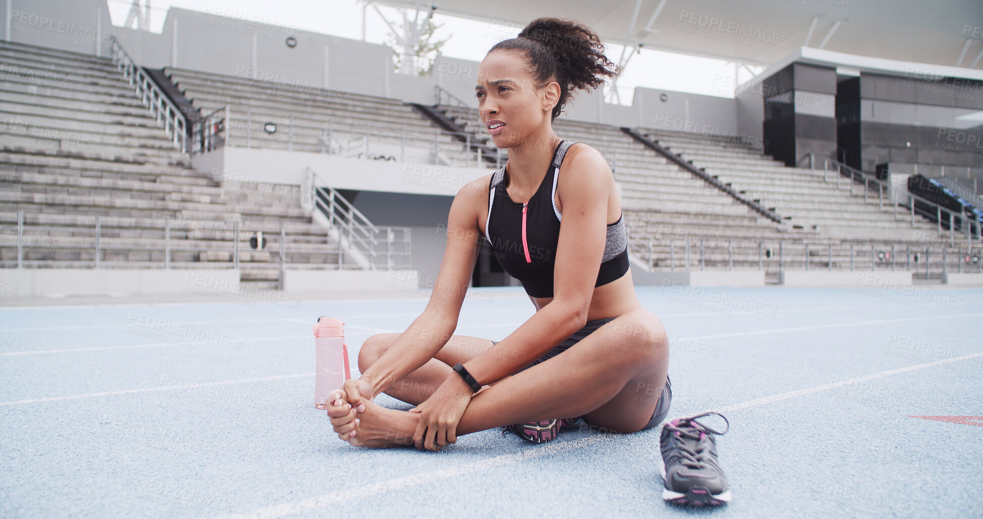 Buy stock photo Exercise, foot injury and massage with woman in stadium for accident or physical emergency. Fitness, inflammation and pain with athlete or runner on track at venue for fatigue or muscle cramp