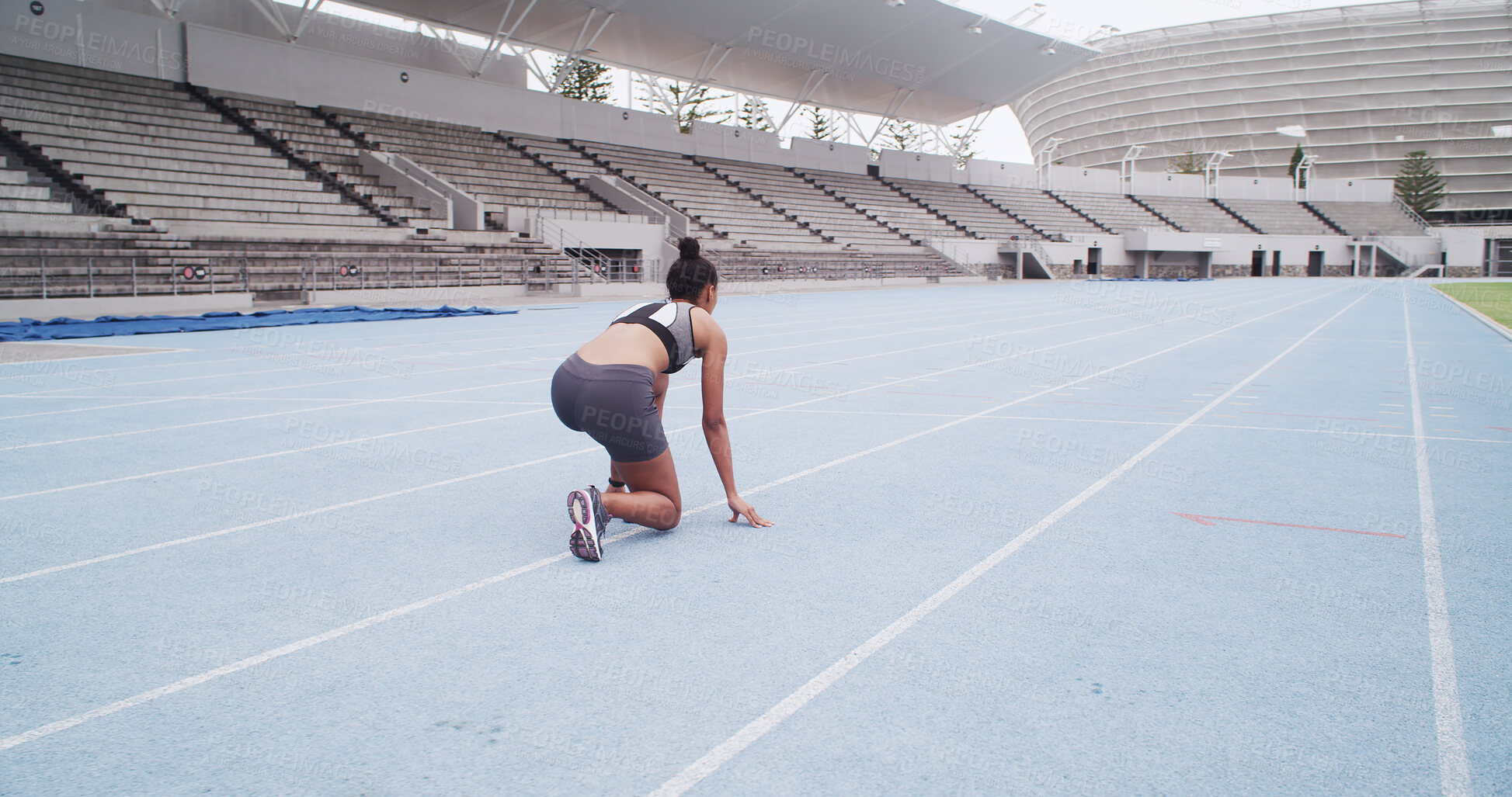 Buy stock photo Back, fitness and start of race with woman in stadium for challenge, competition or sports tournament. Exercise, launch and ready with running athlete at line in arena for event, performance or speed