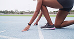 Feet, hands and start of race with woman in stadium for challenge, competition or sports tournament. Exercise, fitness and launch with running athlete at line in arena for event, performance or speed