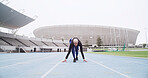 Starting line, track and woman in stadium for running, practice or training for competition. Fitness, runner and female athlete getting ready for race, cardio workout or exercise at sports arena.