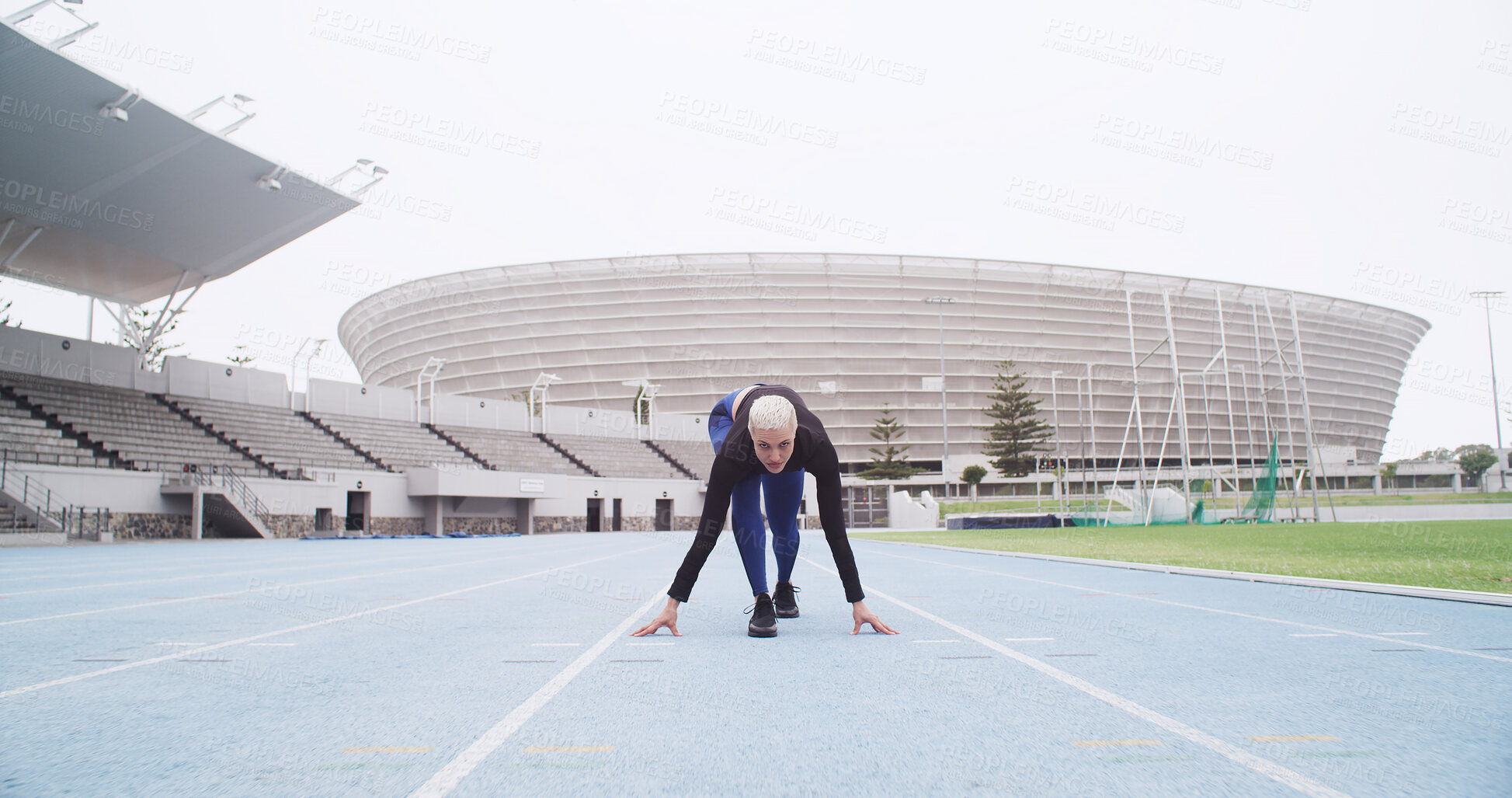 Buy stock photo Starting line, track and woman in stadium for running, practice or training for competition. Fitness, runner and female athlete getting ready for race, cardio workout or exercise at sports arena.