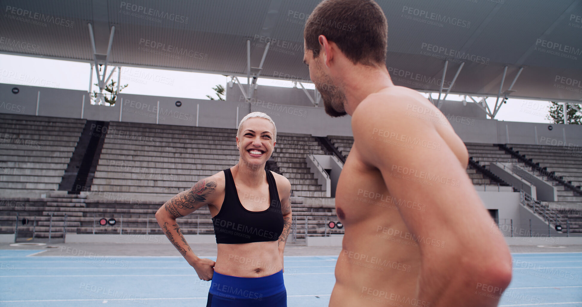 Buy stock photo Athlete, man and woman at track, talk and happy with teamwork, advice and workout for fitness at arena. People, runner and smile with chat, excited or break with training routine at sports stadium
