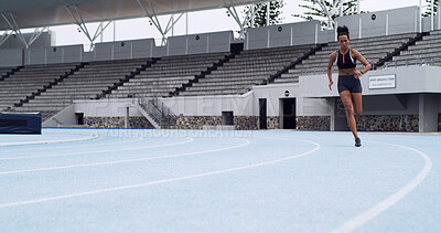 Buy stock photo Athlete, fast runner and woman on race track with fitness, training and cardio performance. Sprinter, speed or female person with running at stadium space for sports, practice and exercise challenge